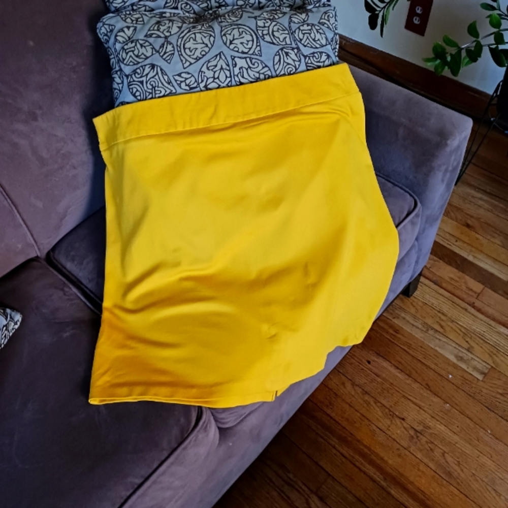 Mustard yellow stretch about knee length skirt.